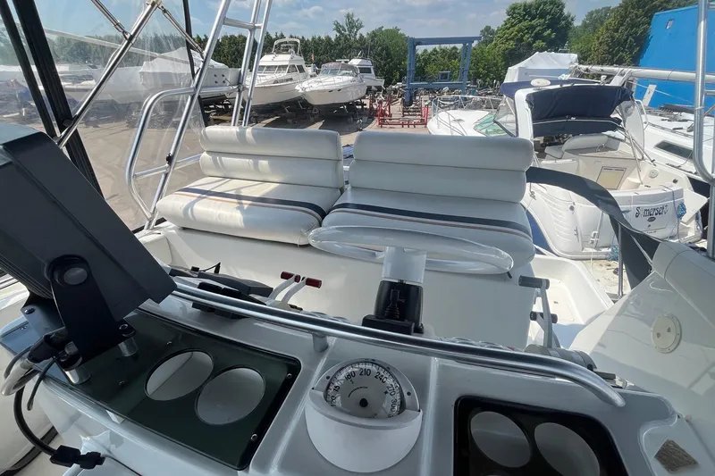Slide: The Image of 1996 Mainship 40 Sedan Bridge yacht interior with helm and seating area. - 19