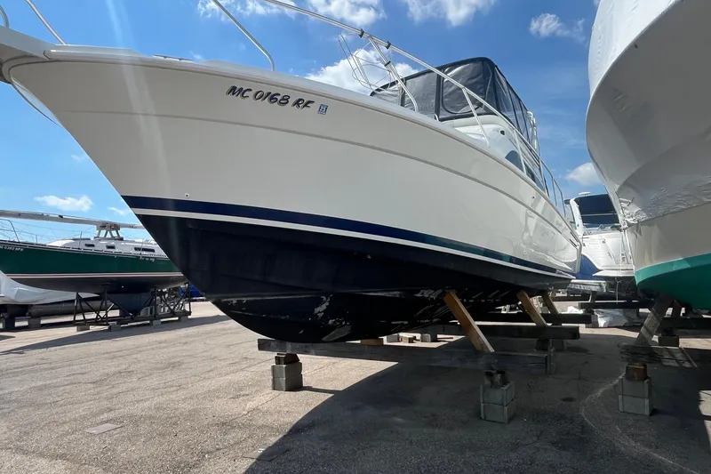 Slide: The Image of 1996 Mainship 40 Sedan Bridge yacht on dry dock under clear blue sky. - 2