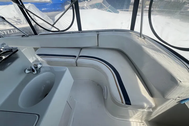 Slide: The Image of Interior of 1996 Mainship 40 Sedan Bridge with seating and sink area. - 21