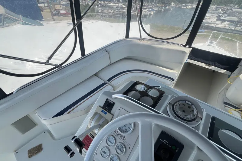 Slide: The Image of Interior view of 1996 Mainship 40 Sedan Bridge helm with gauges and seating. - 22
