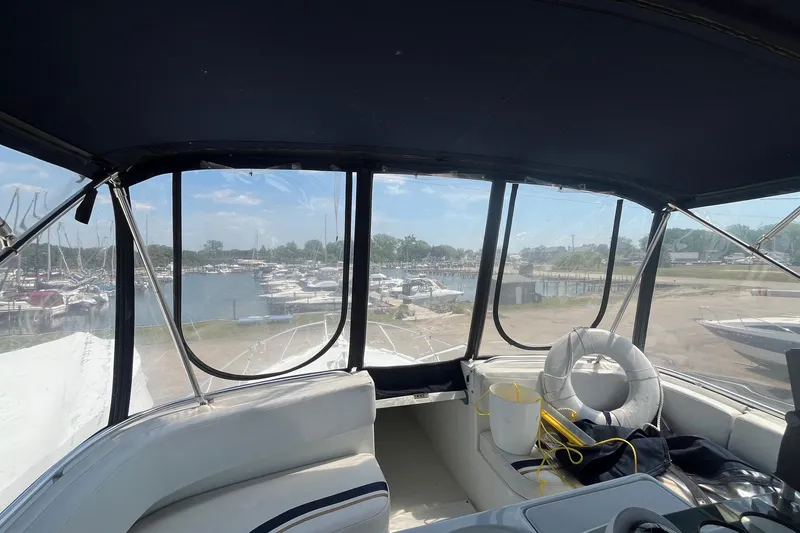 Slide: The Image of Interior view of 1996 Mainship 40 Sedan Bridge yacht overlooking marina. - 24