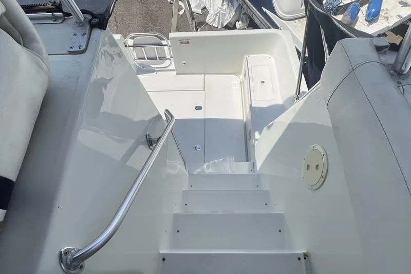 Slide: The Image of Staircase on 1996 Mainship 40 Sedan Bridge yacht, featuring sleek white design and metal handrail. - 26