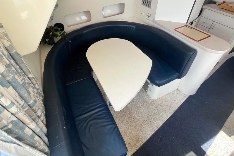 Slide: The Image of Interior of 1996 Mainship 40 Sedan Bridge with blue seating and white table. - 27