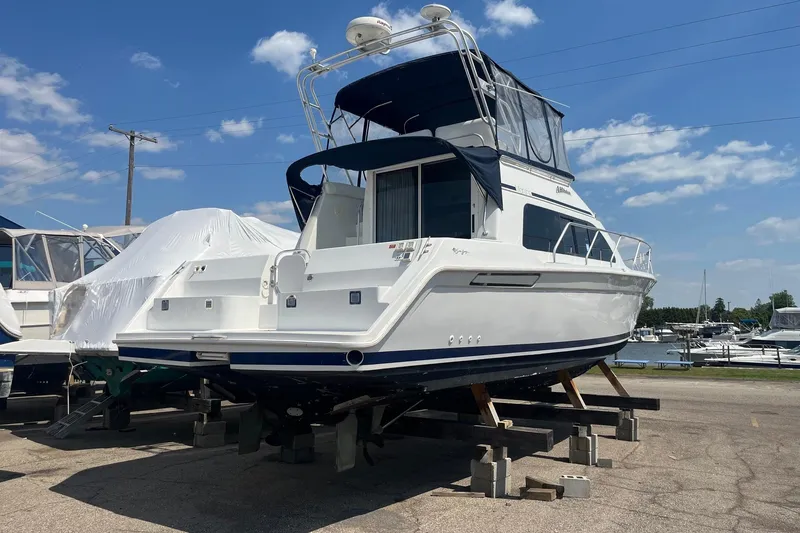 Slide: The Image of 1996 Mainship 40 Sedan Bridge yacht on dry dock under clear blue sky. - 3
