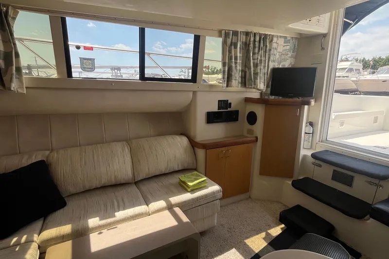 Slide: The Image of Interior of 1996 Mainship 40 Sedan Bridge with sofa, TV, and window view. - 33