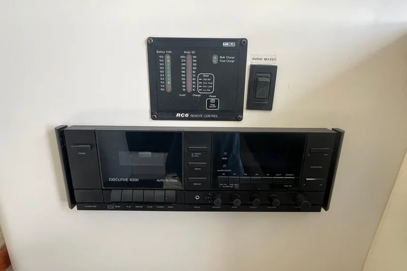 Slide: The Image of 1996 Mainship 40 Sedan Bridge control panel with audio system and battery monitor. - 34