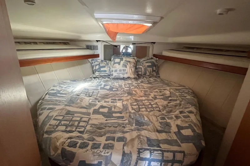 Slide: The Image of Cozy cabin interior of 1996 Mainship 40 Sedan Bridge with patterned bedding. - 39