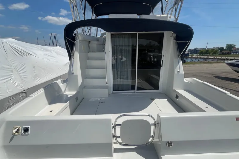 Slide: The Image of 1996 Mainship 40 Sedan Bridge yacht with spacious deck and sliding glass doors. - 7