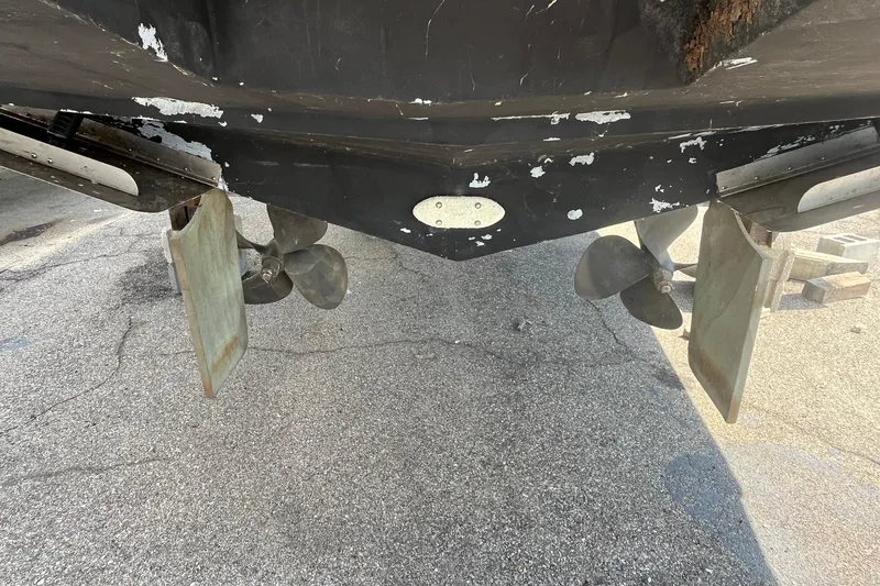 Slide: The Image of 1996 Mainship 40 Sedan Bridge boat underside with propellers and rudders visible. - 8