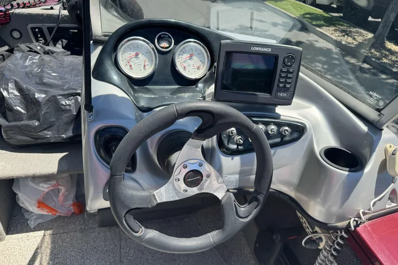 Slide: The Image of 2012 Tracker Targa V-18 Combo boat dashboard with steering wheel and navigation system. - 17