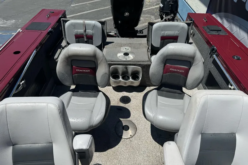Slide: The Image of 2012 Tracker Targa V-18 Combo boat interior with four gray seats and cup holders. - 21