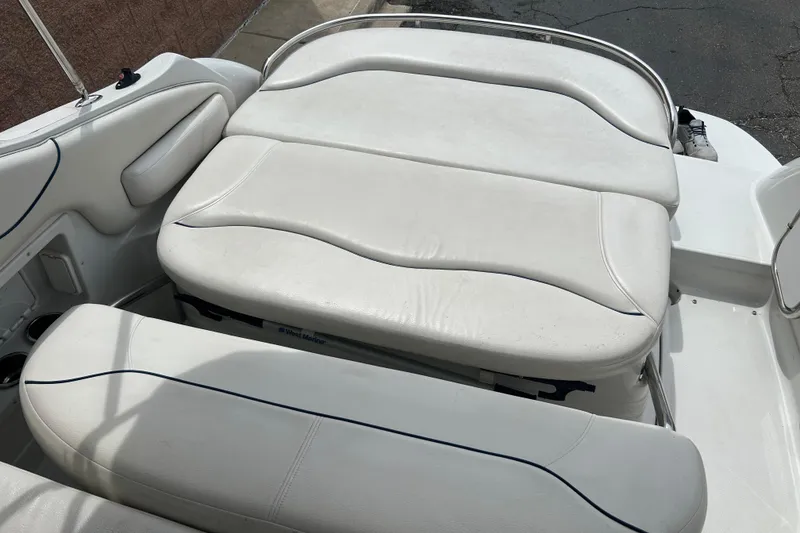 Slide: The Image of 2006 Crownline 270 CR boat interior with white cushioned seating. - 16