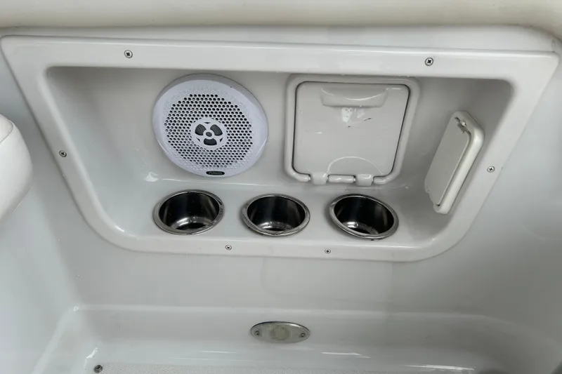 Slide: The Image of 2006 Crownline 270 CR boat interior with speaker and cup holders. - 17
