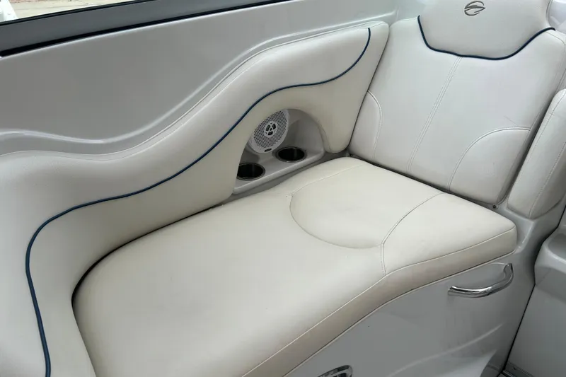 Slide: The Image of 2006 Crownline 270 CR boat interior with white cushioned seating and built-in cup holders. - 19