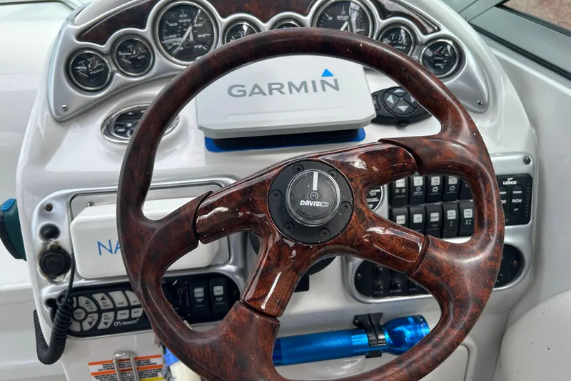 Slide: The Image of Steering wheel and dashboard of a 2006 Crownline 270 CR boat with Garmin navigation. - 21