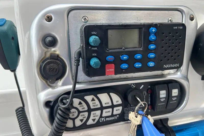 Slide: The Image of Control panel of a 2006 Crownline 270 CR boat with Navman VHF radio. - 23