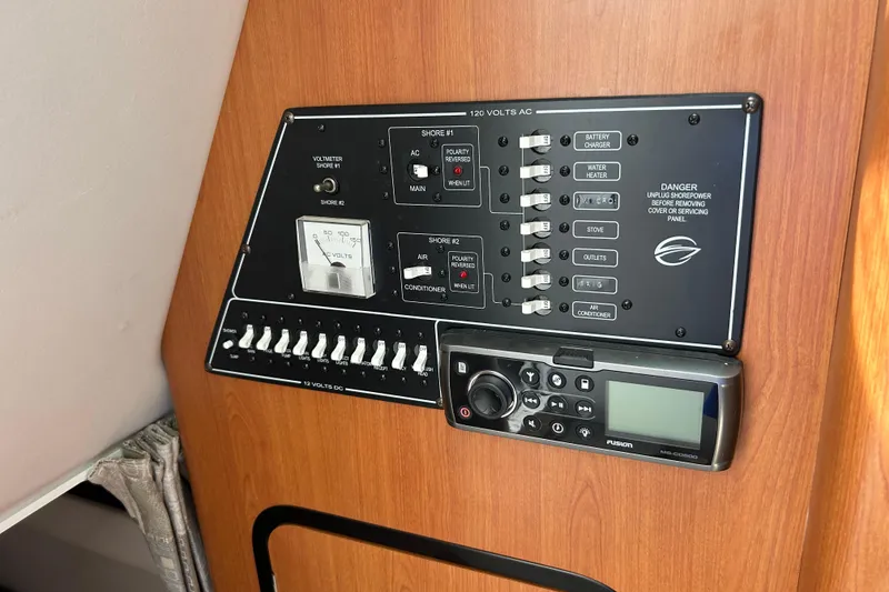 Slide: The Image of Control panel of a 2006 Crownline 270 CR boat, featuring switches and a Fusion stereo. - 31