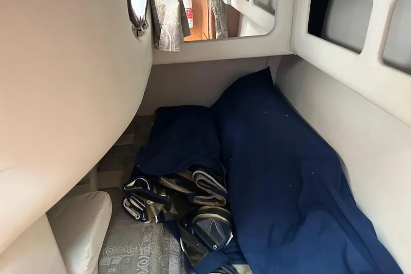 Slide: The Image of Interior cabin of a 2006 Crownline 270 CR boat with blue bedding. - 34