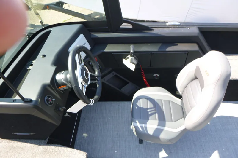 Slide: The Image of 2024 Alumacraft Competitor 185X Sport boat interior with steering wheel and captain's chair. - 10