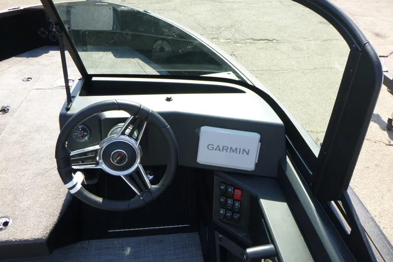 Slide: The Image of 2024 Alumacraft Competitor 185X Sport dashboard with Garmin navigation system and steering wheel. - 11