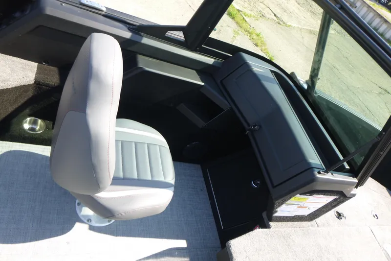 Slide: The Image of 2024 Alumacraft Competitor 185X Sport interior with gray seating and dashboard. - 12