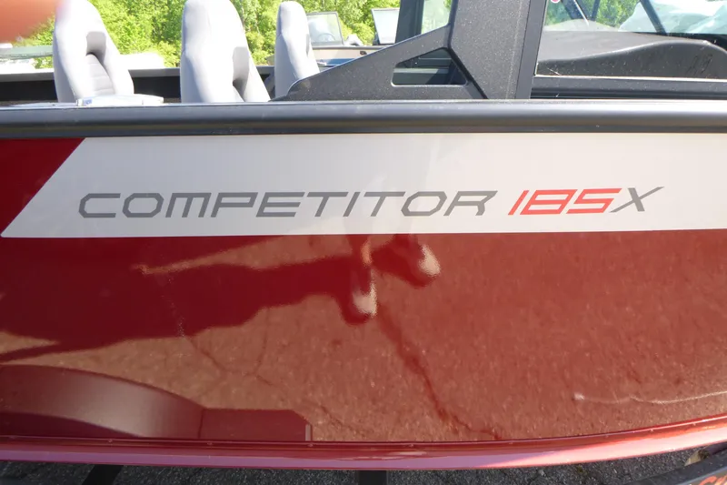Slide: The Image of 2024 Alumacraft Competitor 185X Sport boat, red exterior with model name displayed. - 18