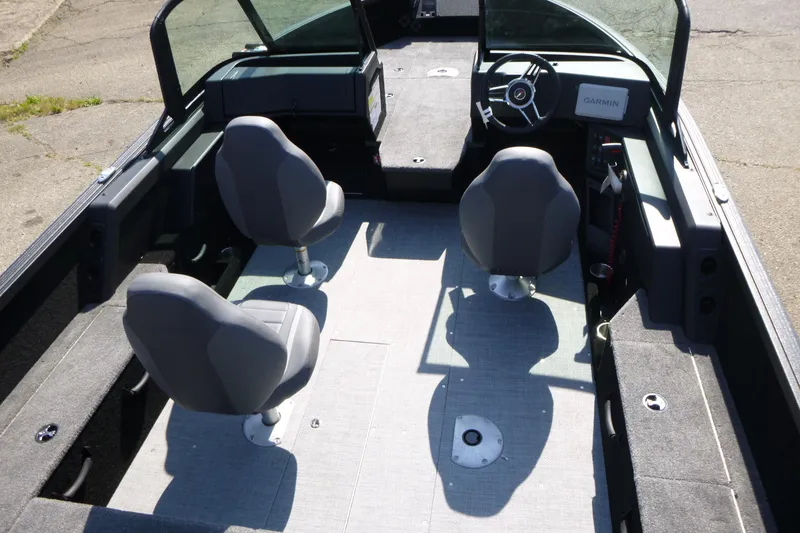 Slide: The Image of 2024 Alumacraft Competitor 185X Sport interior with two seats and steering console. - 5