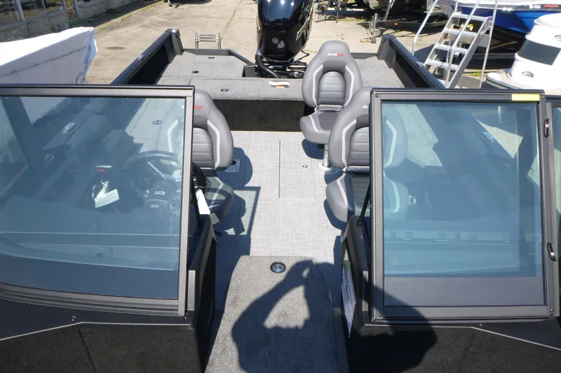 Slide: The Image of 2024 Alumacraft Competitor 185X Sport boat interior with seating and windshield. - 6