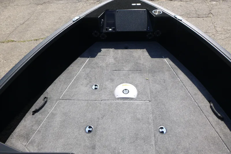 Slide: The Image of 2024 Alumacraft Competitor 185X Sport boat interior with carpeted deck and storage compartments. - 7