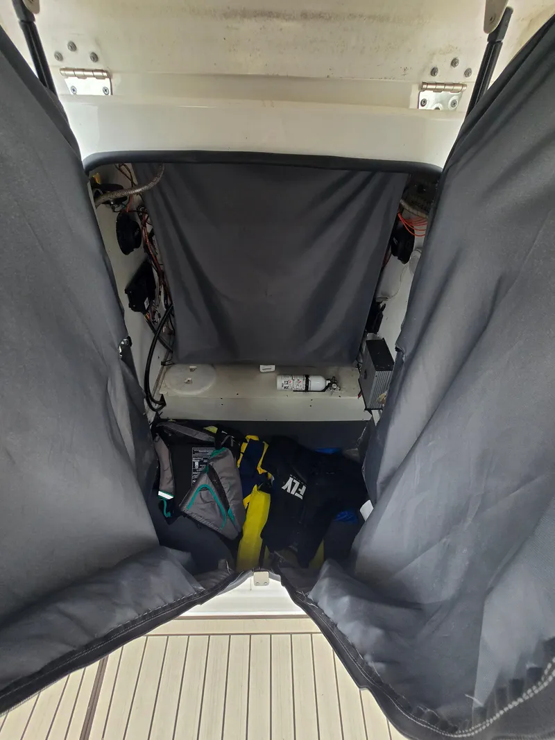 Slide: The Image of Interior of a 2022 Yamaha 255 FSH Sport E boat, featuring wooden flooring. - 18