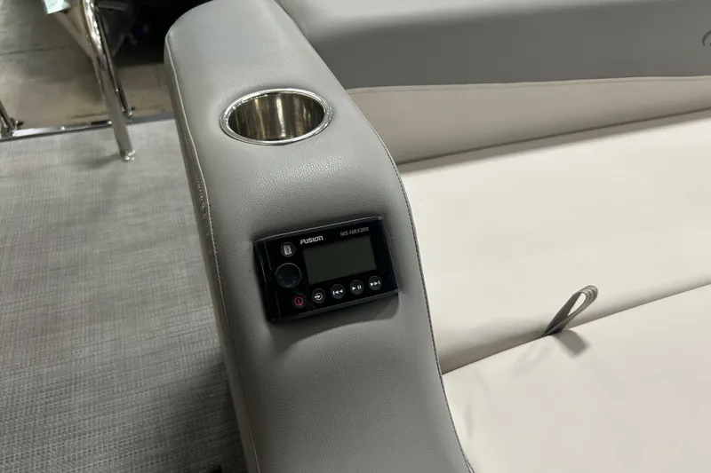 Slide: The Image of 2022 Manitou 25 Encore boat interior with cup holder and Fusion MS-RA90 stereo. - 18
