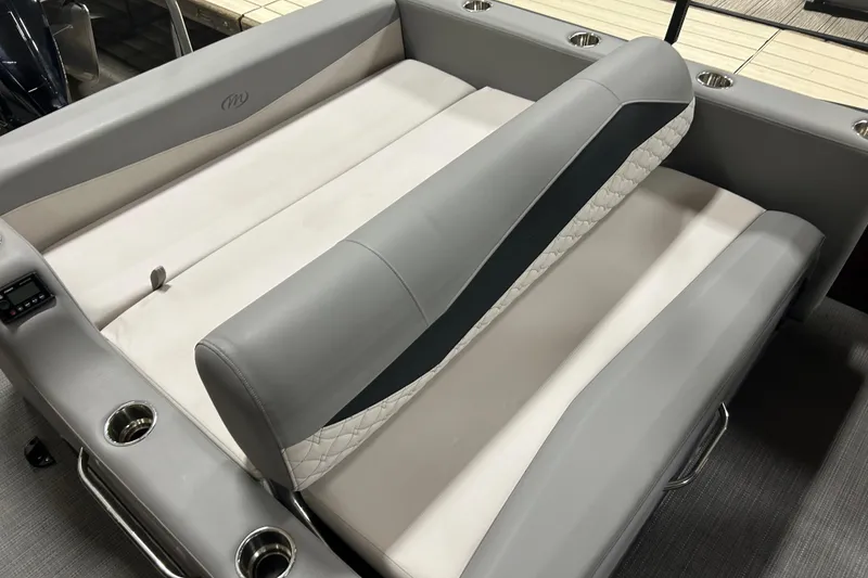 Slide: The Image of 2022 Manitou 25 Encore boat seating with gray upholstery and cup holders. - 21