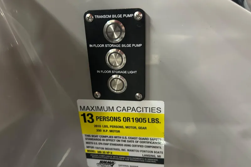 Slide: The Image of Control panel and capacity label on 2022 Manitou 25 Encore boat, indicating 13-person limit. - 28