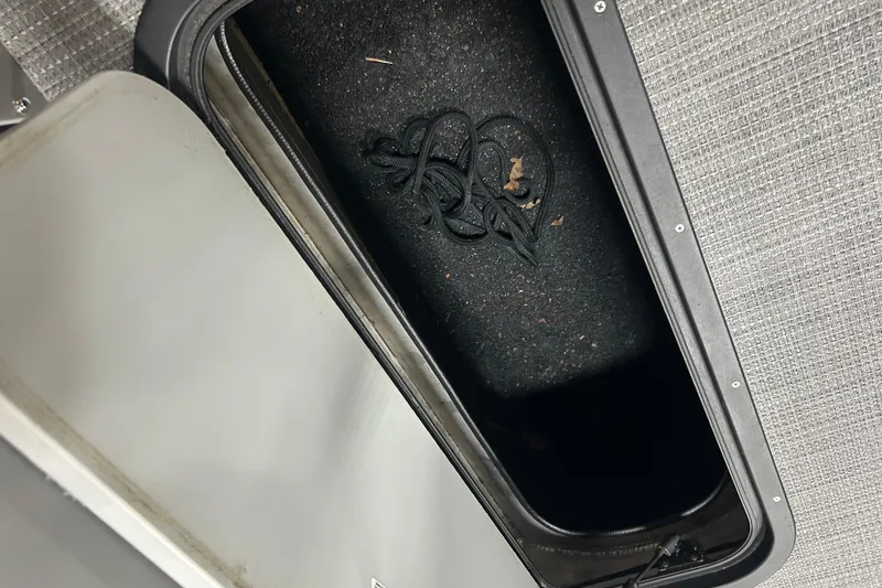 Slide: The Image of Storage compartment in 2022 Manitou 25 Encore boat with rope inside. - 30