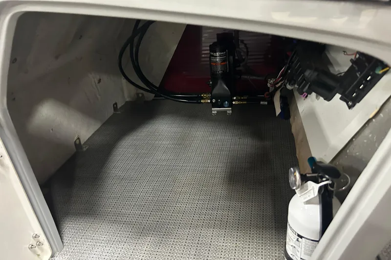 Slide: The Image of 2022 Manitou 25 Encore interior compartment with equipment and fire extinguisher. - 31