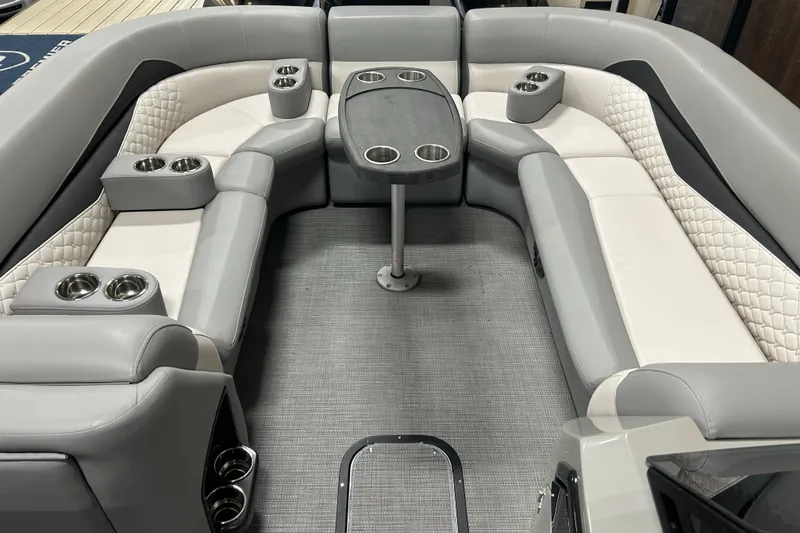 Slide: The Image of Luxurious seating area on 2022 Manitou 25 Encore pontoon boat with cup holders and table. - 32