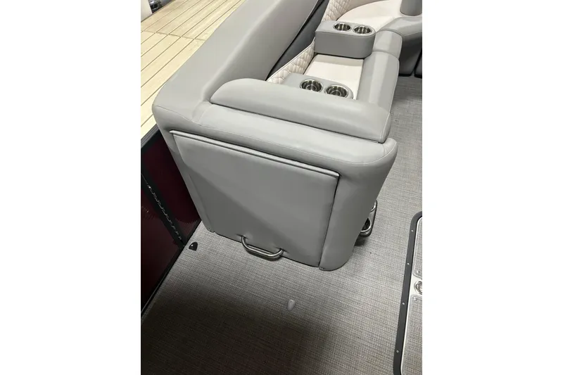 Slide: The Image of 2022 Manitou 25 Encore boat interior with gray seating and cup holders. - 34