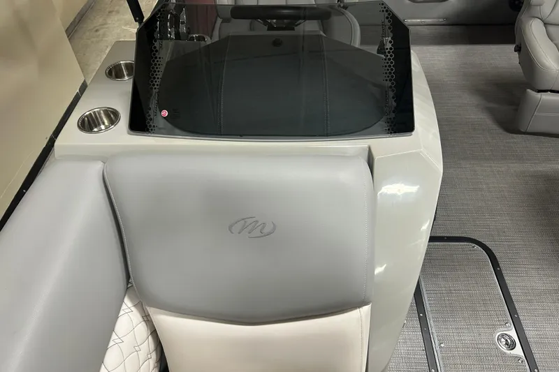 Slide: The Image of 2022 Manitou 25 Encore boat interior with gray seating and cup holders. - 35