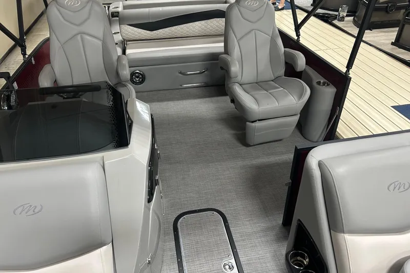 Slide: The Image of Interior of a 2022 Manitou 25 Encore pontoon boat with luxurious seating and modern design. - 37