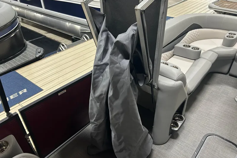 Slide: The Image of 2022 Manitou 25 Encore boat interior with seating and storage compartments. - 38
