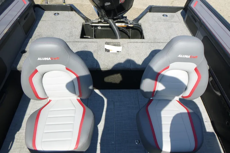 Slide: The Image of 2025 Alumacraft Trophy 185X Sport boat interior with two gray and red seats. - 14