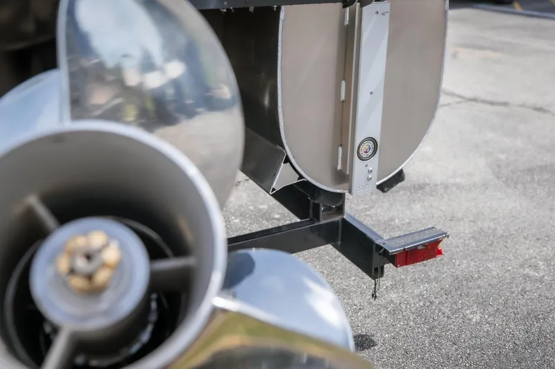 Slide: The Image of Close-up of JC Sporttoon 26TT 2026 boat propeller and rudder on pavement. - 10