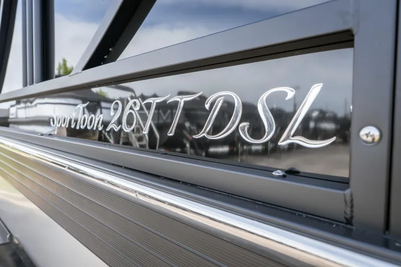 Slide: The Image of JC Sporttoon 26TT 2026 model nameplate on sleek black surface. - 12