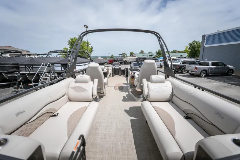 Slide: The Image of 2026 JC Sporttoon 26TT pontoon boat with luxurious seating in a marina setting. - 15