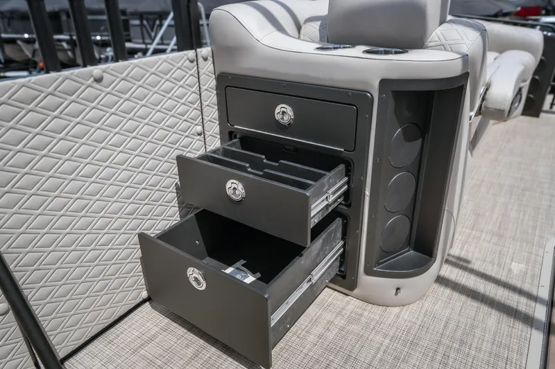 Slide: The Image of Interior of 2026 JC Sporttoon 26TT boat with open storage drawers and cup holders. - 29