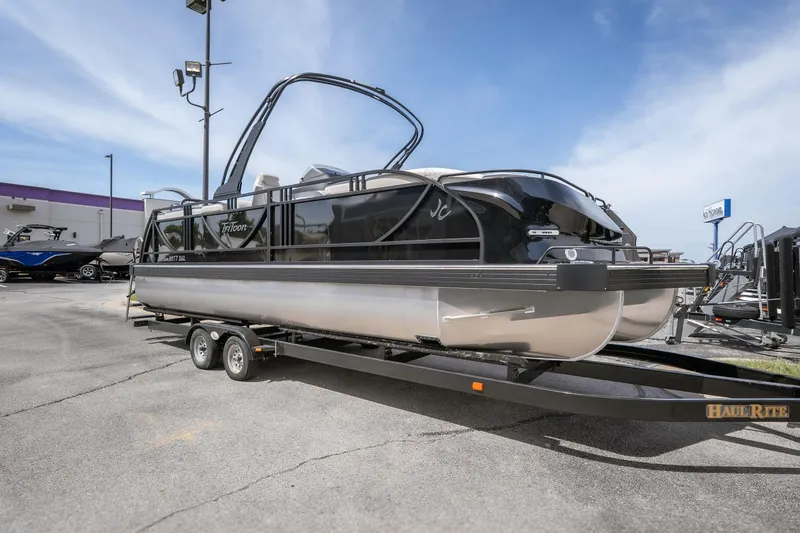 Slide: The Image of 2026 JC Sporttoon 26TT pontoon boat on trailer under clear sky. - 3