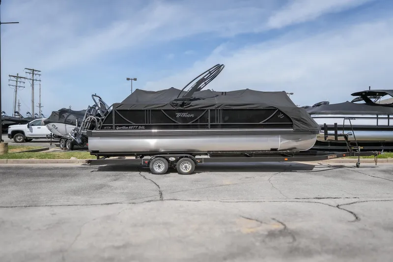 Slide: The Image of 2026 JC Sporttoon 26TT pontoon boat on trailer, covered, parked outdoors. - 37