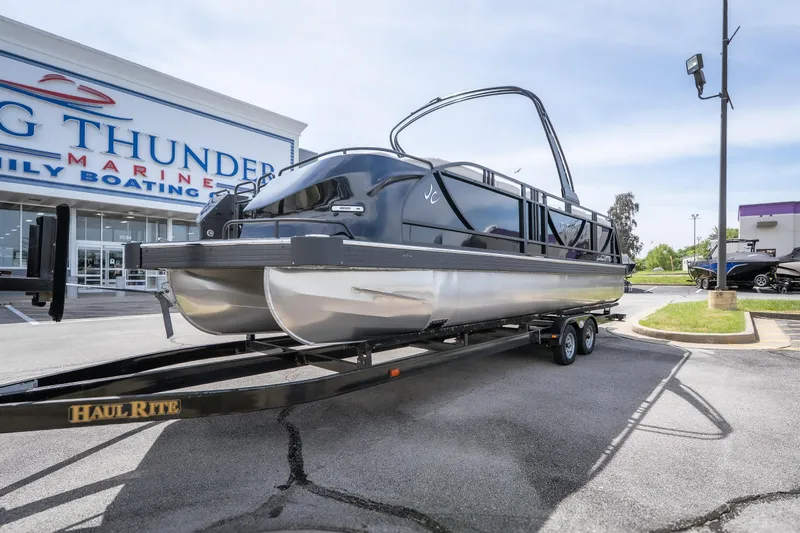 Slide: The Image of 2026 JC Sporttoon 26TT pontoon boat on trailer at dealership. - 5