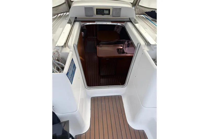 Slide: The Image of 2007 Hunter 38 sailboat interior view with wooden flooring and cabin entrance. - 14