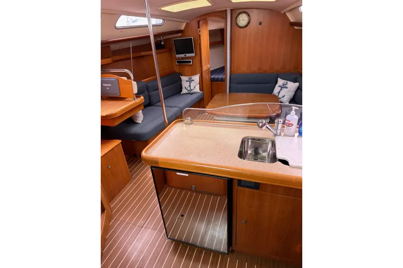 Slide: The Image of Interior of 2007 Hunter 38 sailboat with cozy seating and compact kitchen area. - 15